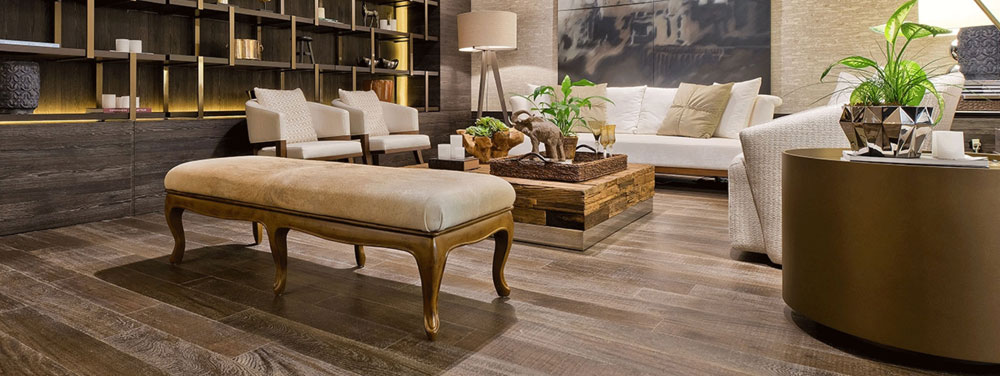 hardwood flooring in living room with white furniture and bronze shelving